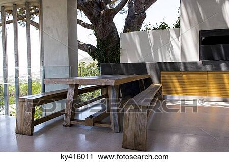 Picnic table and bench in a porch View Large Photo Image Stock Image - Picnic table and bench in a porch. Fotosearch