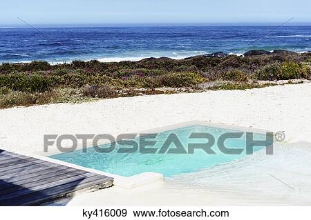 Stock Photo - Swimming pool near the sea. Fotosearch
