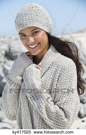 Stock Photography - Beautiful woman enjoying on the beach in winter. Fotosearch