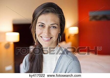 Portrait of a woman smiling in a hotel room View Large Photo Image Stock Image - Portrait of a woman smiling in a hotel room. Fotosearch