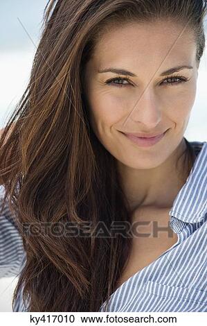 Portrait of a woman smiling on the beach View Large Photo Image Stock Image - Portrait of a woman smiling on the beach. Fotosearch