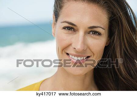 Portrait of a woman smiling on the beach View Large Photo Image Stock Photo - Portrait of a woman smiling on the beach. Fotosearch