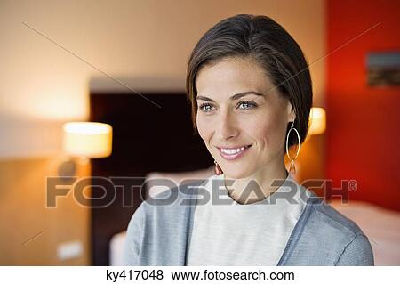 Woman smiling in a hotel room View Large Photo Image Stock Photo - Woman smiling in a hotel room. Fotosearch