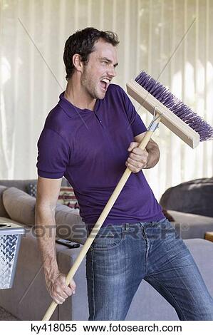 Man dancing with a mop View Large Photo Image Stock Photography - Man dancing with a mop. Fotosearch