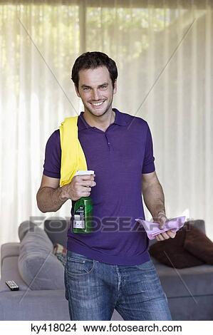 Picture - Man holding cleaning equipment and smiling. Fotosearch