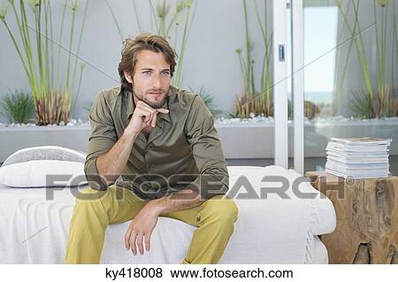 Man sitting at home and thinking View Large Photo Image Stock Photo - Man sitting at home and thinking. Fotosearch