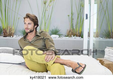 Stock Image - Man sitting at home. Fotosearch