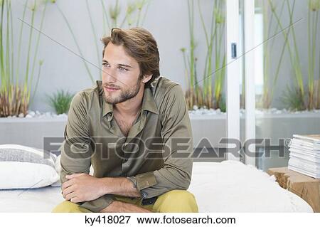 Man sitting at home View Large Photo Image Stock Photo - Man sitting at home. Fotosearch