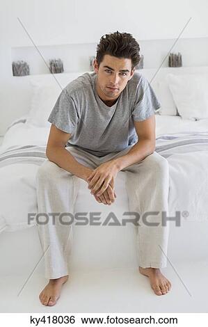 Man sitting on the bed View Large Photo Image Stock Photograph - Man sitting on the bed. Fotosearch