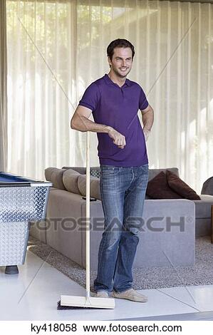 Man standing with a mop and smiling View Large Photo Image Stock Photo - Man standing with a mop and smiling. Fotosearch