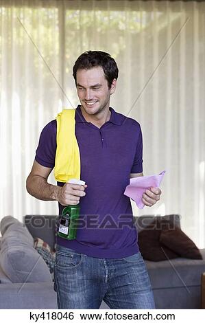 Smiling man holding cleaning equipment View Large Photo Image Stock Photograph - Smiling man holding cleaning equipment. Fotosearch