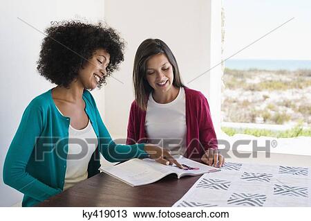 Friends reading a magazine View Large Photo Image Stock Image - Friends reading a magazine. Fotosearch