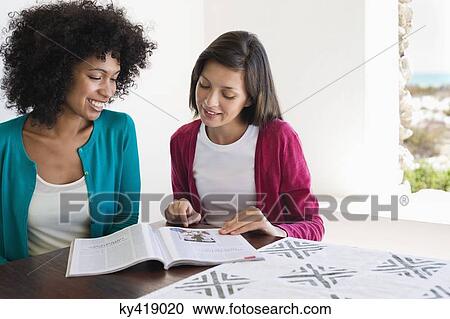 Friends reading a magazine View Large Photo Image Stock Image - Friends reading a magazine. Fotosearch
