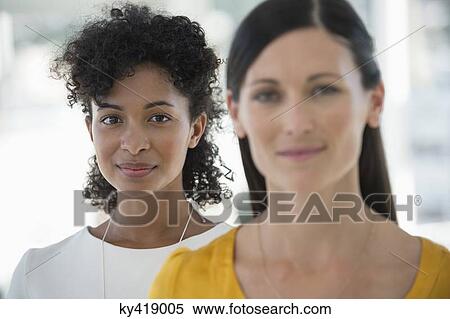 Stock Photography - Portrait of a two female friends smiling. Fotosearch