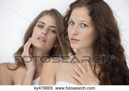 Stock Image - Portrait of two female friends posing. Fotosearch