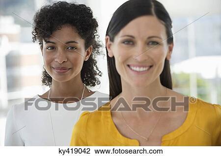 Portrait of two female friends smiling together View Large Photo Image Stock Image - Portrait of two female friends smiling together. Fotosearch