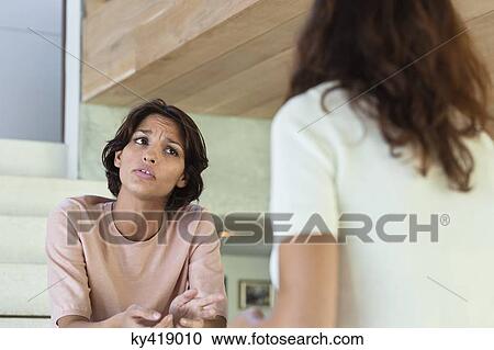 Two female friends arguing at home View Large Photo Image Stock Image - Two female friends arguing at home. Fotosearch