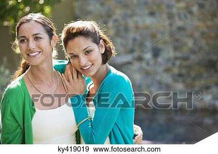 Stock Photo - Two female friends smiling together. Fotosearch
