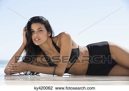 Beautiful woman in bikini lying on the beach View Large Photo Image Stock Image - Beautiful woman in bikini lying on the beach. Fotosearch