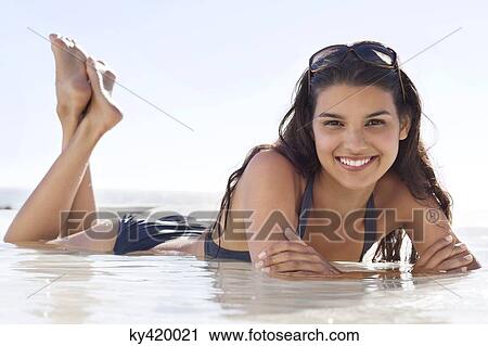 Beautiful woman lying on the beach View Large Photo Image Stock Image - Beautiful woman lying on the beach. Fotosearch