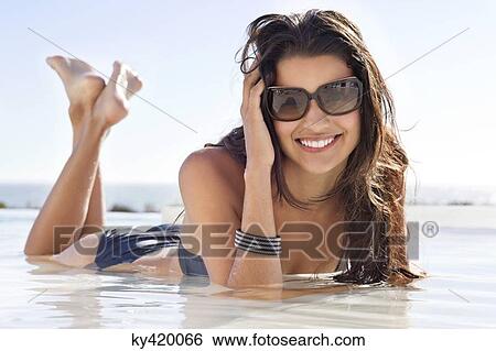 Beautiful woman lying on the beach View Large Photo Image Stock Photograph - Beautiful woman lying on the beach. Fotosearch
