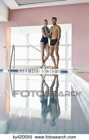 Stock Photography - Couple standing at the poolside. Fotosearch