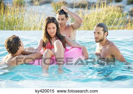Group of friends enjoying in a swimming pool on the beach View Large Photo Image Stock Photography - Group of friends enjoying in a swimming pool on the beach. Fotosearch