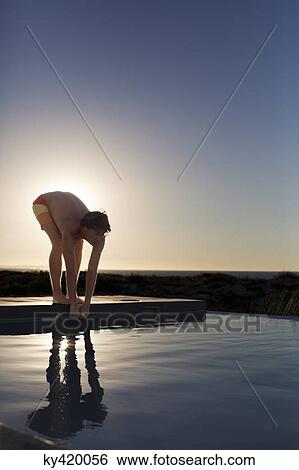 Man about to jump into a swimming pool View Large Photo Image Stock Photograph - Man about to jump into a swimming pool. Fotosearch