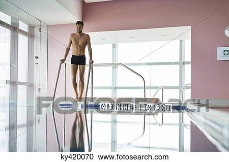 Man standing at the poolside View Large Photo Image Stock Image - Man standing at the poolside. Fotosearch