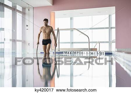 Stock Photo - Man standing in a swimming pool. Fotosearch