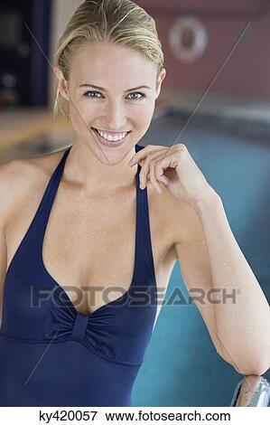 Portrait of a beautiful woman smiling at the poolside View Large Photo Image Stock Photo - Portrait of a beautiful woman smiling at the poolside. Fotosearch