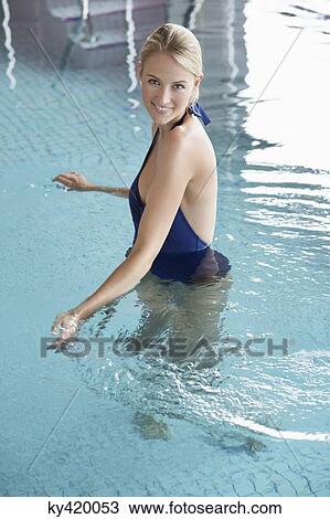 Portrait of a woman standing in a swimming pool View Large Photo Image Stock Image - Portrait of a woman standing in a swimming pool. Fotosearch