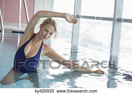 Portrait of a woman swimming in a swimming pool View Large Photo Image Stock Image - Portrait of a woman swimming in a swimming pool. Fotosearch
