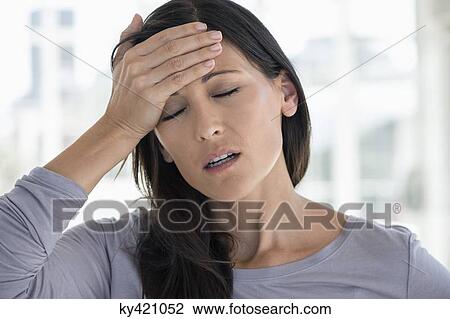 Close-up of a woman suffering from a headache View Large Photo Image Stock Image - Close-up of a woman suffering from a headache. Fotosearch