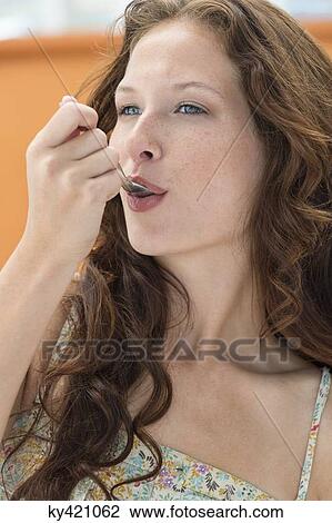 Close-up of a woman taking medicine with a spoon View Large Photo Image Stock Image - Close-up of a woman taking medicine with a spoon. Fotosearch