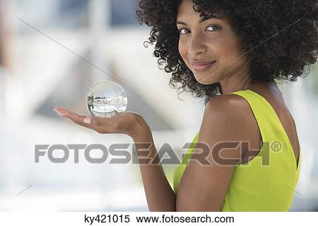 Portrait of a woman holding a crystal ball View Large Photo Image Stock Photography - Portrait of a woman holding a crystal ball. Fotosearch