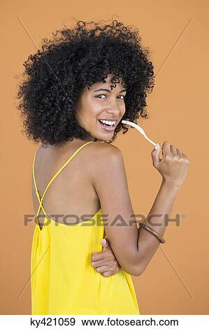Portrait of a woman holding a fork and smiling View Large Photo Image Stock Photo - Portrait of a woman holding a fork and smiling. Fotosearch