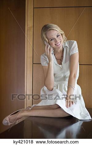 Portrait of a woman talking on a mobile phone and smiling View Large Photo Image Stock Photo - Portrait of a woman talking on a mobile phone and smiling. Fotosearch