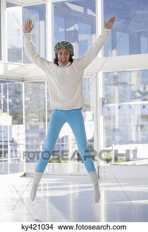 Portrait of an excited woman jumping View Large Photo Image Picture - Portrait of an excited woman jumping. Fotosearch