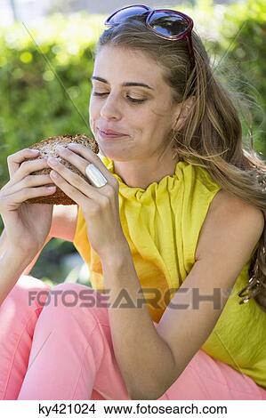 Woman eating sandwich View Large Photo Image Picture - Woman eating sandwich. Fotosearch