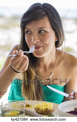 Picture - Woman enjoying lunch. Fotosearch
