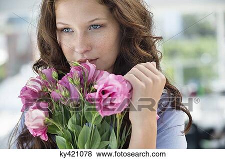 Stock Photo - Woman holding a bouquet of flowers. Fotosearch
