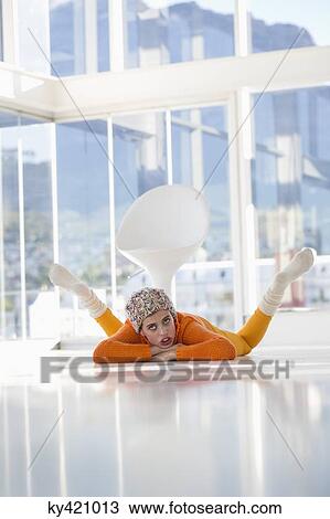 Stock Image - Woman lying on the floor. Fotosearch