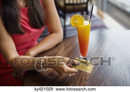 Woman paying with a credit card on a table in a restaurant View Large Photo Image Stock Photo - Woman paying with a credit card on a table in a restaurant. Fotosearch