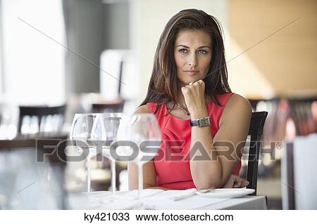 Woman sitting in a restaurant and thinking View Large Photo Image Stock Image - Woman sitting in a restaurant and thinking. Fotosearch
