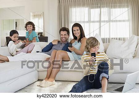Family using electronics gadget View Large Photo Image Stock Image - Family using electronics gadget. Fotosearch