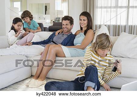 Stock Photo - Family using electronics gadget. Fotosearch