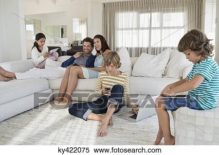Family using electronics gadget View Large Photo Image Stock Photography - Family using electronics gadget. Fotosearch