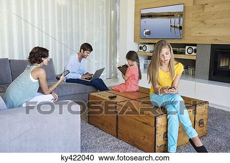 Family using electronics gadgets View Large Photo Image Stock Image - Family using electronics gadgets. Fotosearch