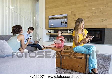 Family using electronics gadgets View Large Photo Image Stock Image - Family using electronics gadgets. Fotosearch
